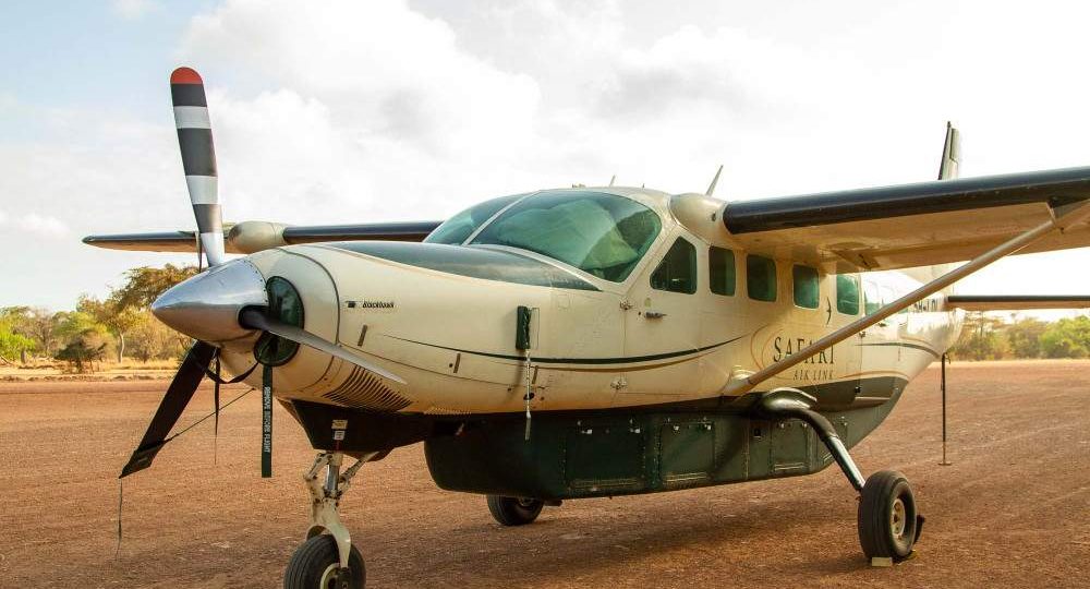 Light safari aircraft on a bush airstrip, used for one day fly-in safaris from Zanzibar to Nyerere and Mikumi